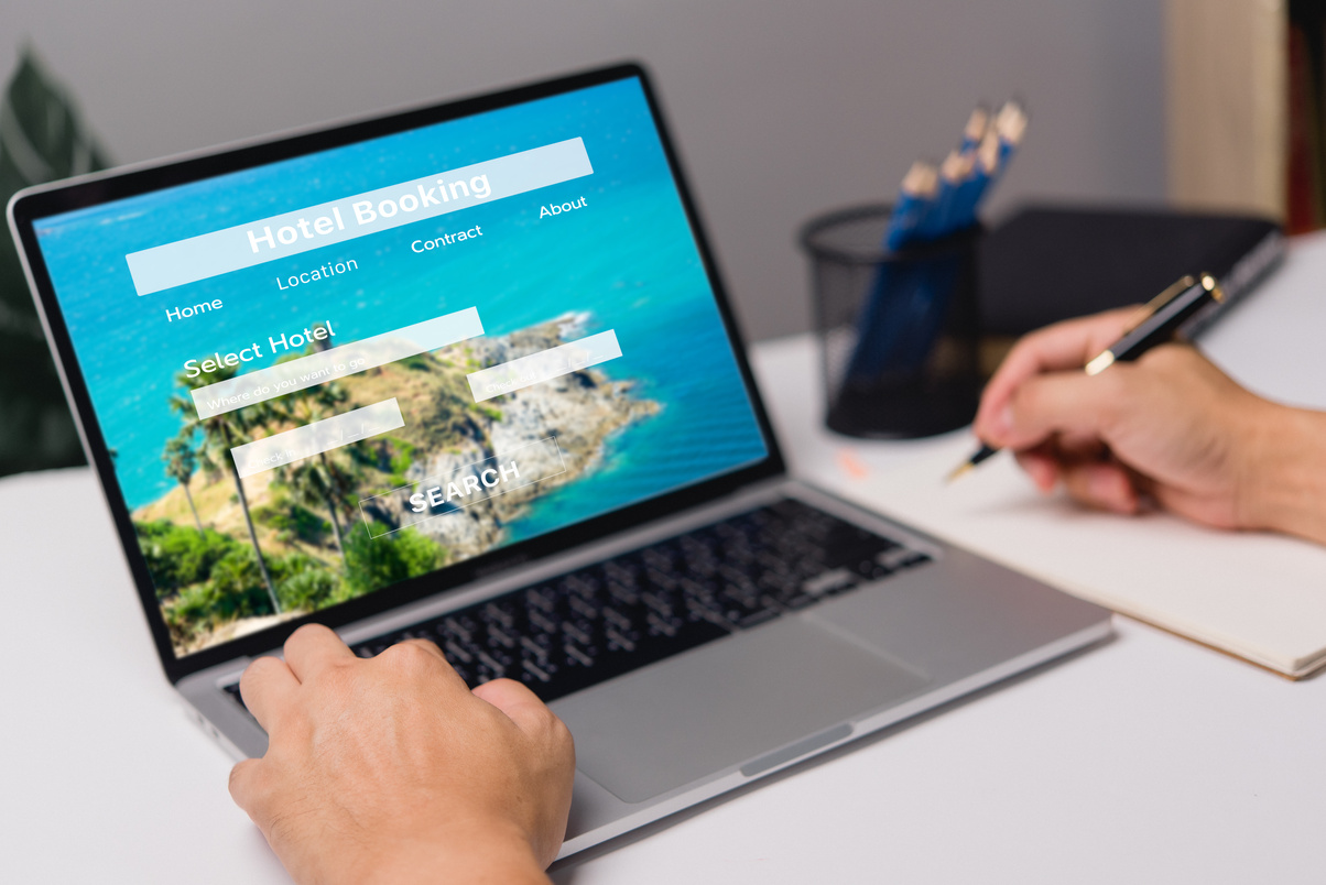 booking online concept, person using laptop computer planning travel search hotel booking.